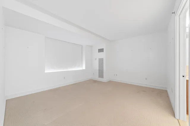 an empty room with a empty space and windows