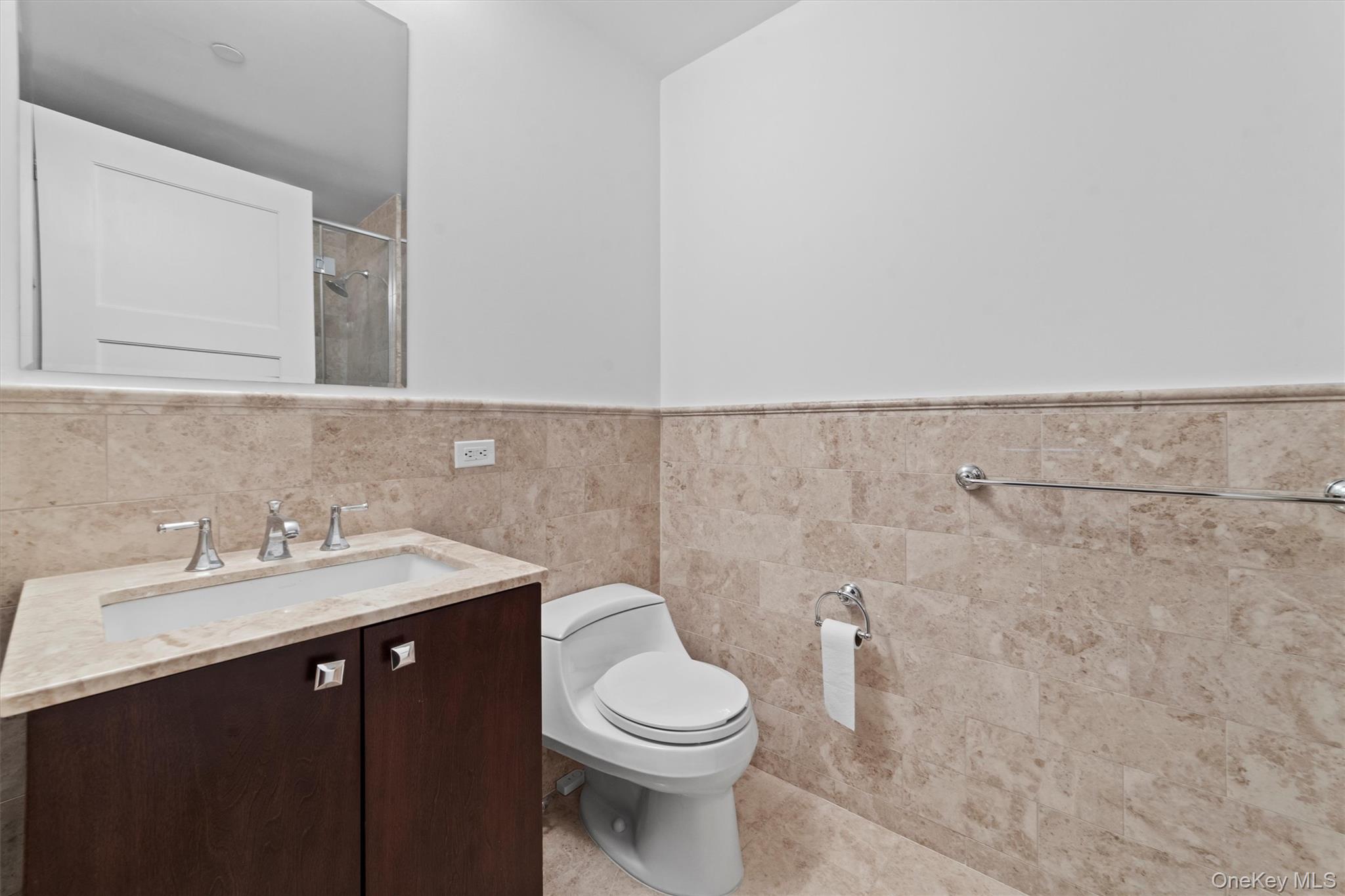 5 Renaissance Square, Unit 10G White Plains, NY 10601 - Photo 27 of 28 a bathroom with a sink and a toilet