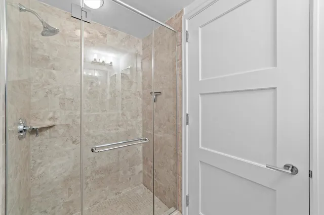 a bathroom with a glass shower door