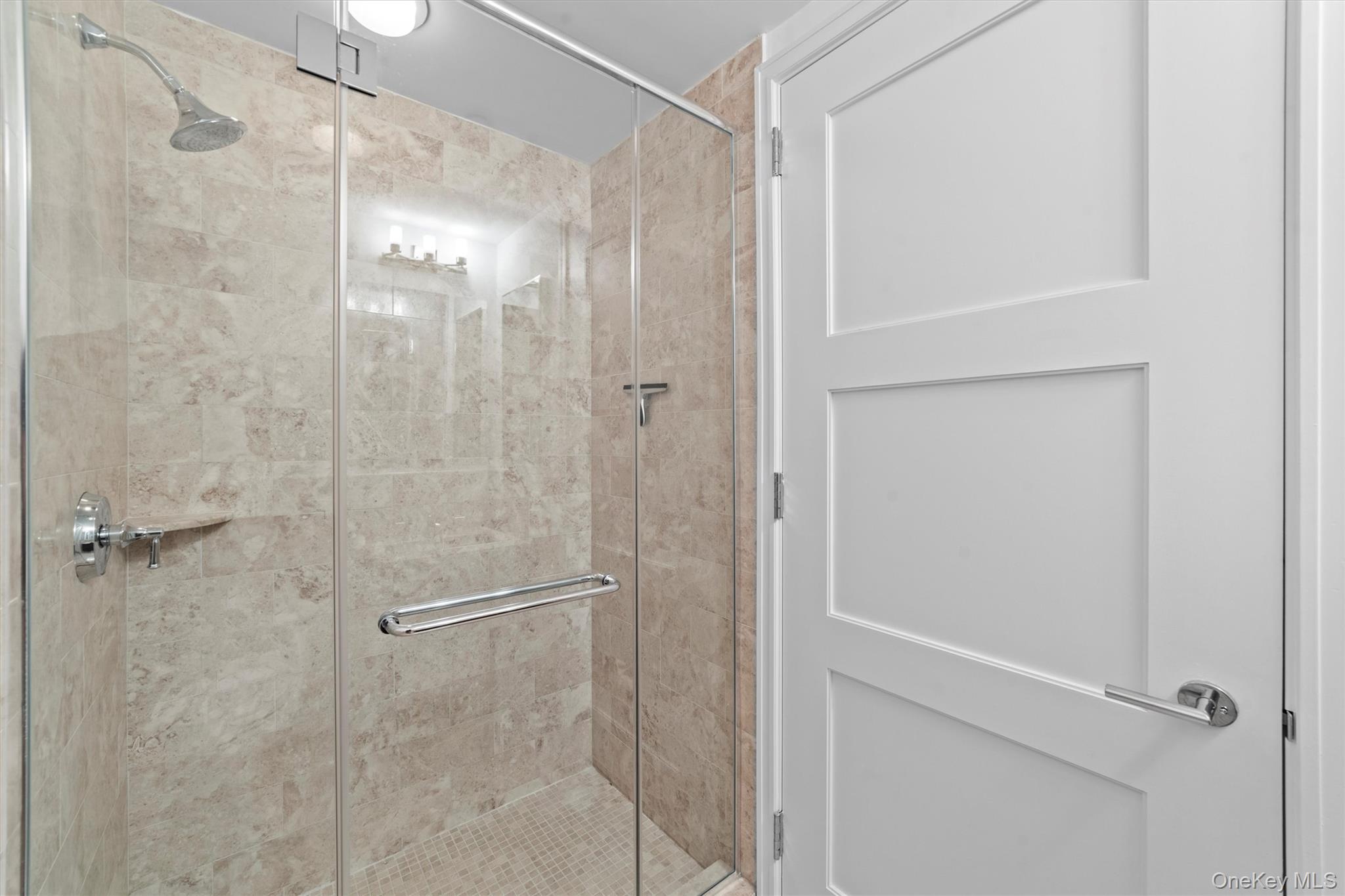 5 Renaissance Square, Unit 10G White Plains, NY 10601 - Photo 28 of 28 a bathroom with a glass shower door