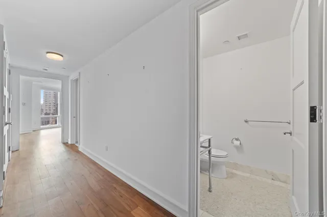 a view of a hallway with wooden floor