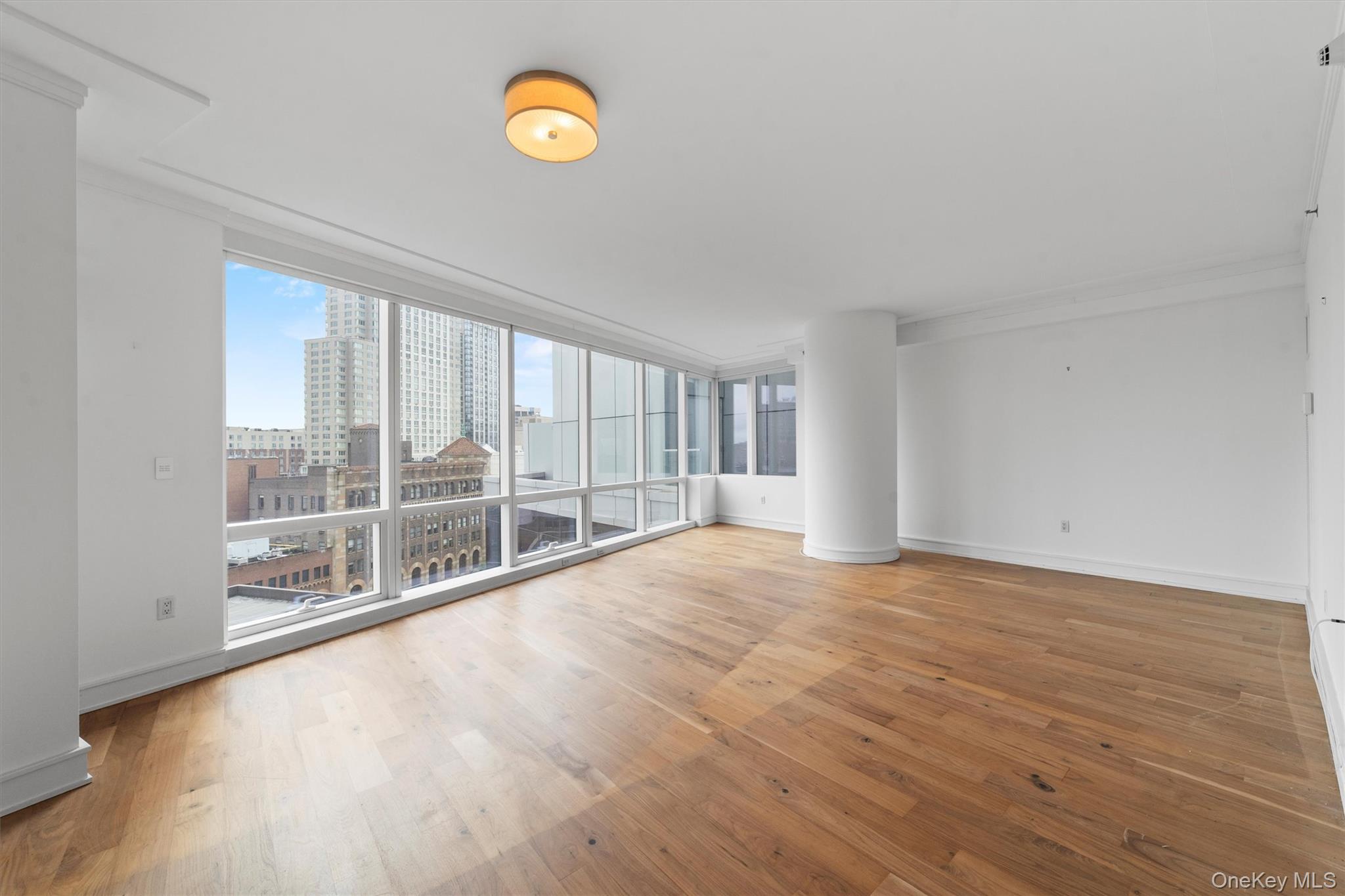 5 Renaissance Square, Unit 10G White Plains, NY 10601 - Photo 4 of 28 a view of an empty room with a window