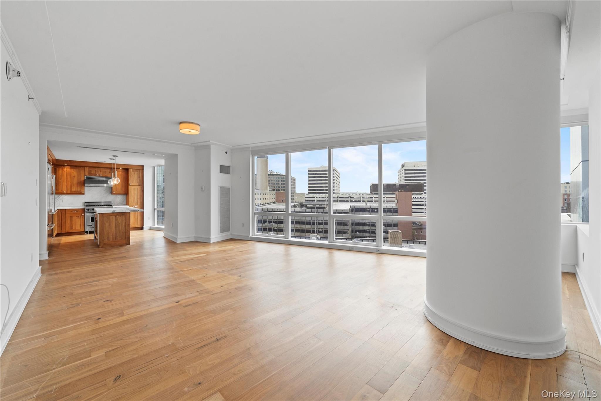 5 Renaissance Square, Unit 10G White Plains, NY 10601 - Photo 5 of 28 wooden floor in an empty room with a window