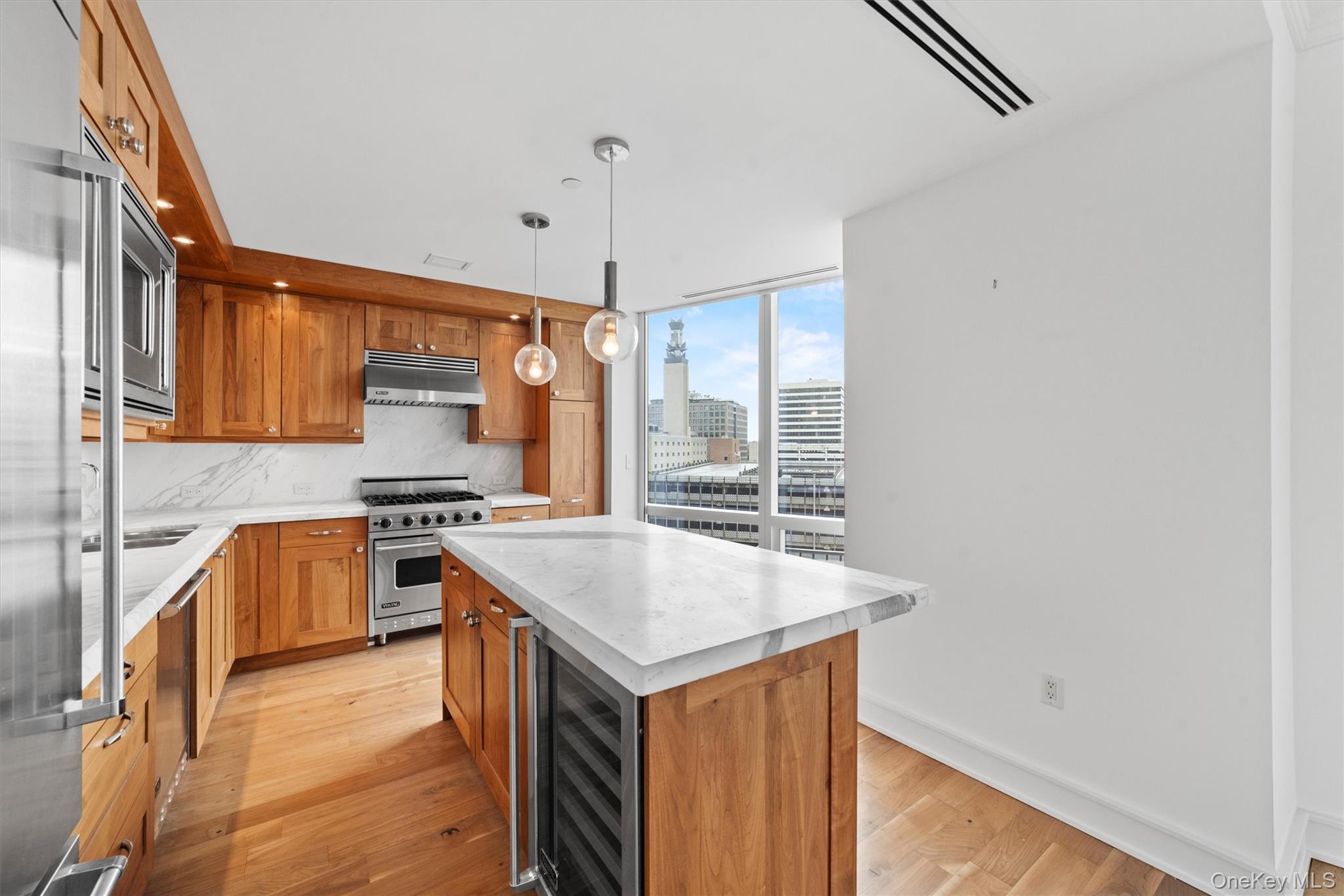 5 Renaissance Square, Unit 10G White Plains, NY 10601 - Photo 7 of 28 a kitchen with stainless steel appliances granite countertop a stove and a sink