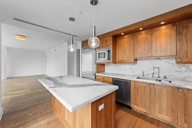 a kitchen with a sink a stove a refrigerator and cabinets