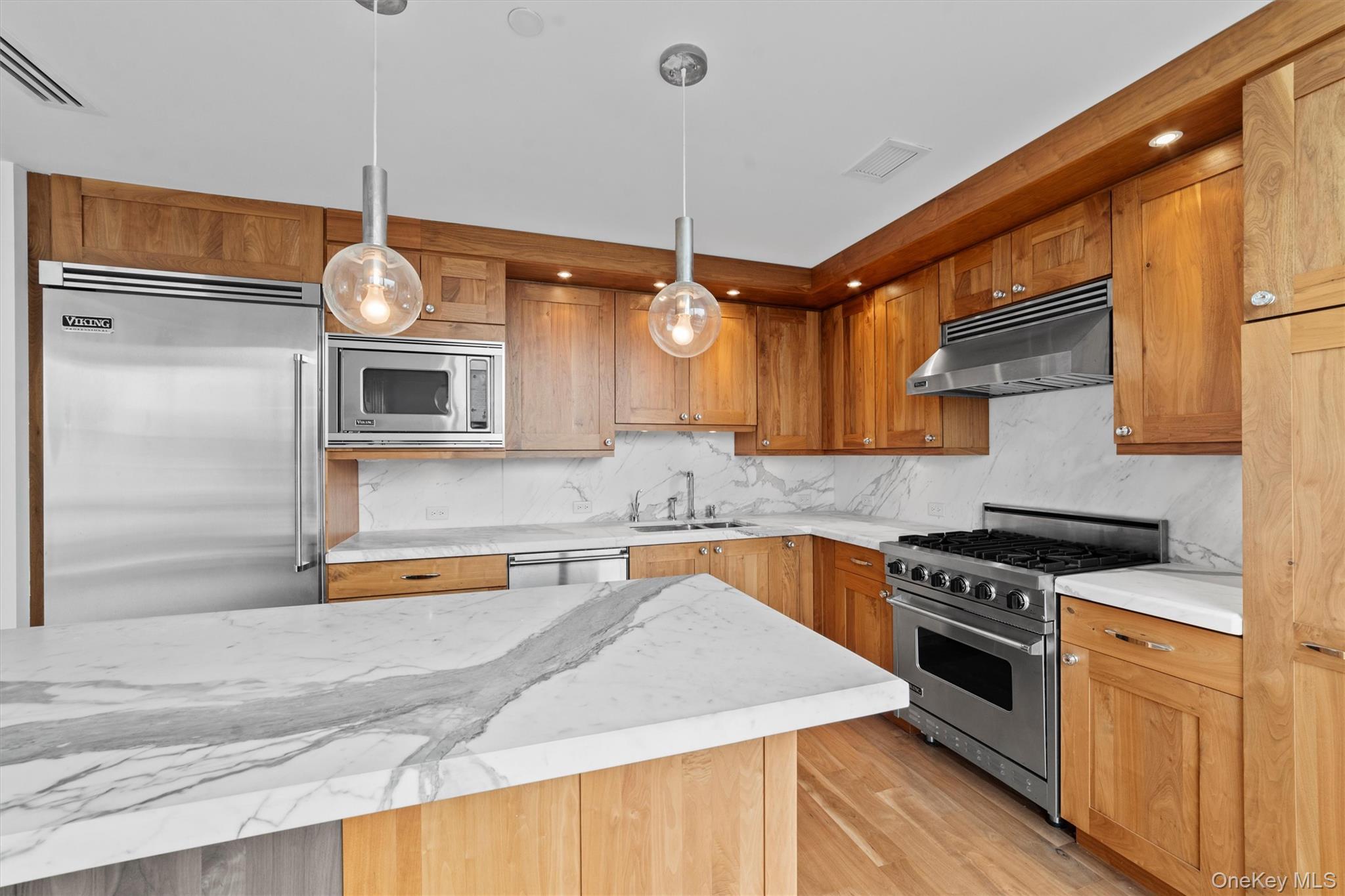 5 Renaissance Square, Unit 10G White Plains, NY 10601 - Photo 10 of 28 a kitchen with stainless steel appliances granite countertop a sink a stove and a wooden floors