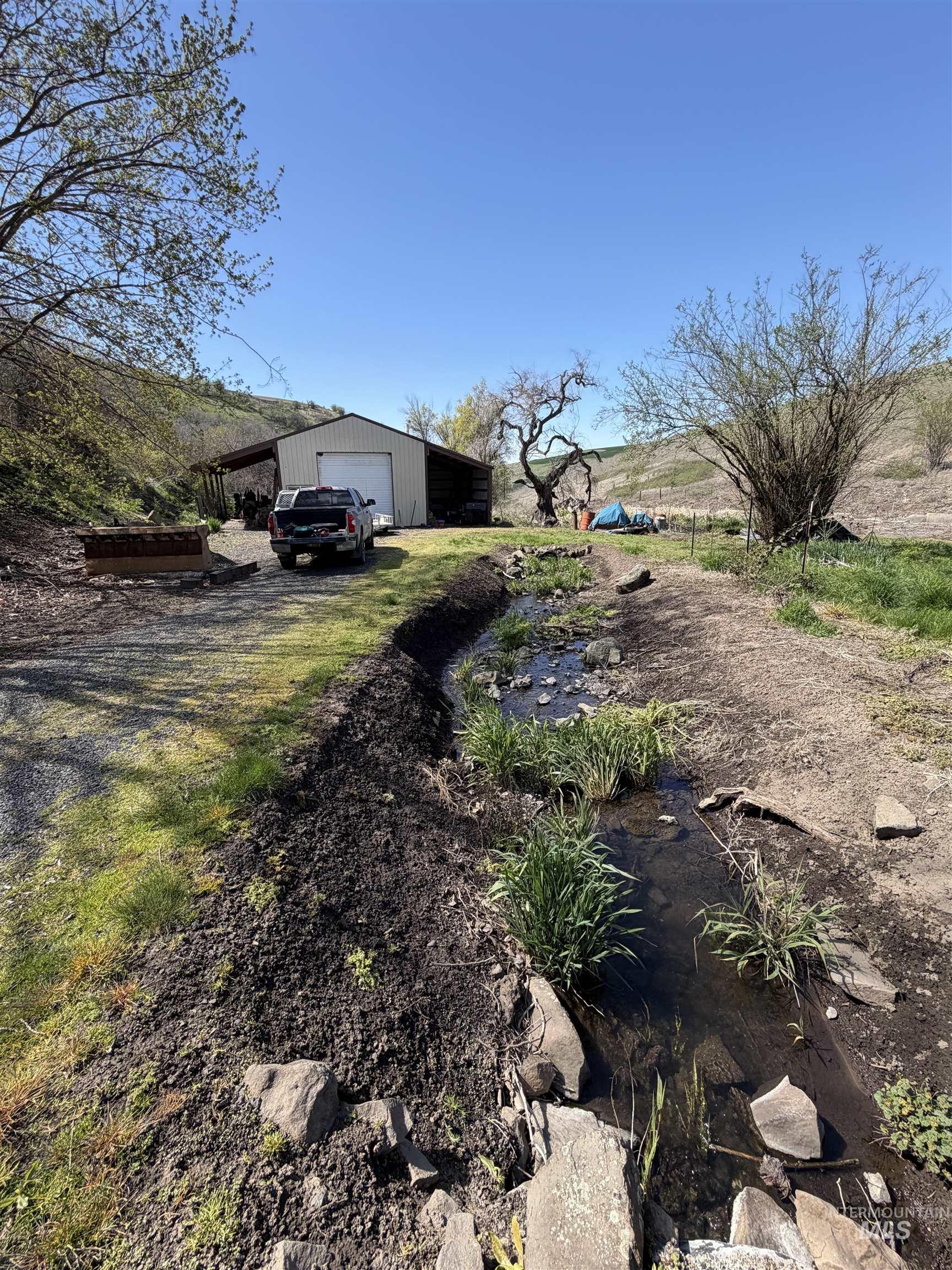 27474 North Tom Beall Road Lapwai, ID 83540 - Photo 15 of 50 View of yard with a garage, driveway, and an outbuilding
