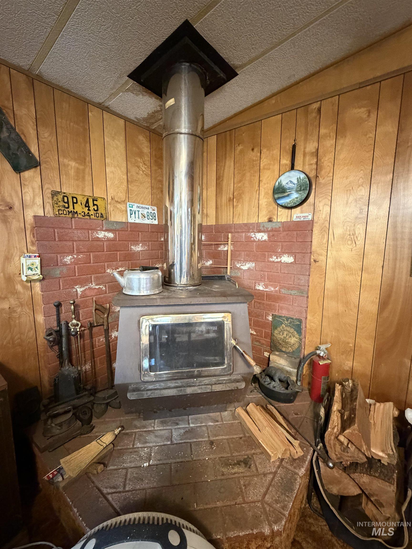 27474 North Tom Beall Road Lapwai, ID 83540 - Photo 30 of 50 Detailed view of a wood stove and wooden walls