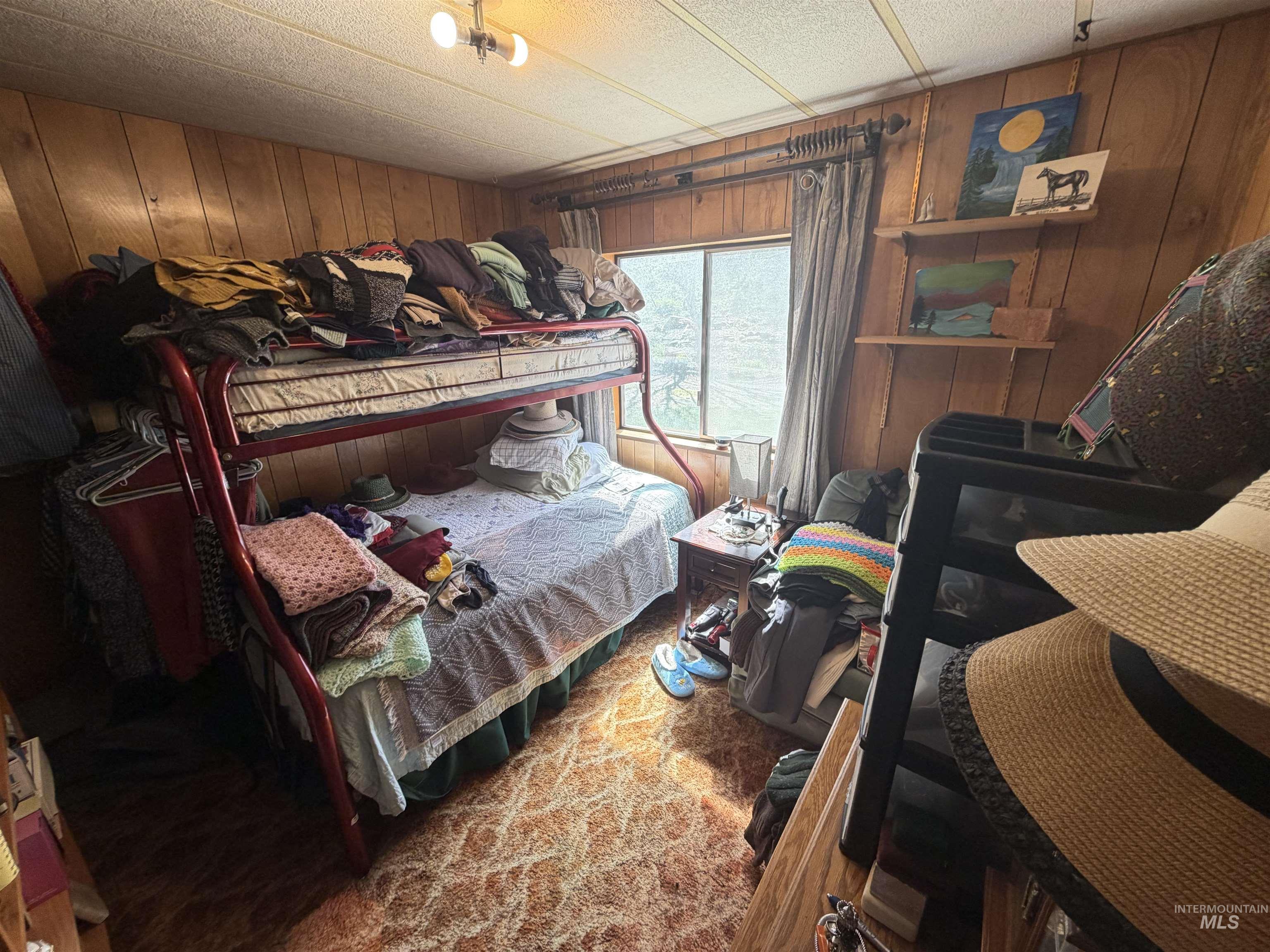 27474 North Tom Beall Road Lapwai, ID 83540 - Photo 32 of 50 Carpeted bedroom featuring wood walls