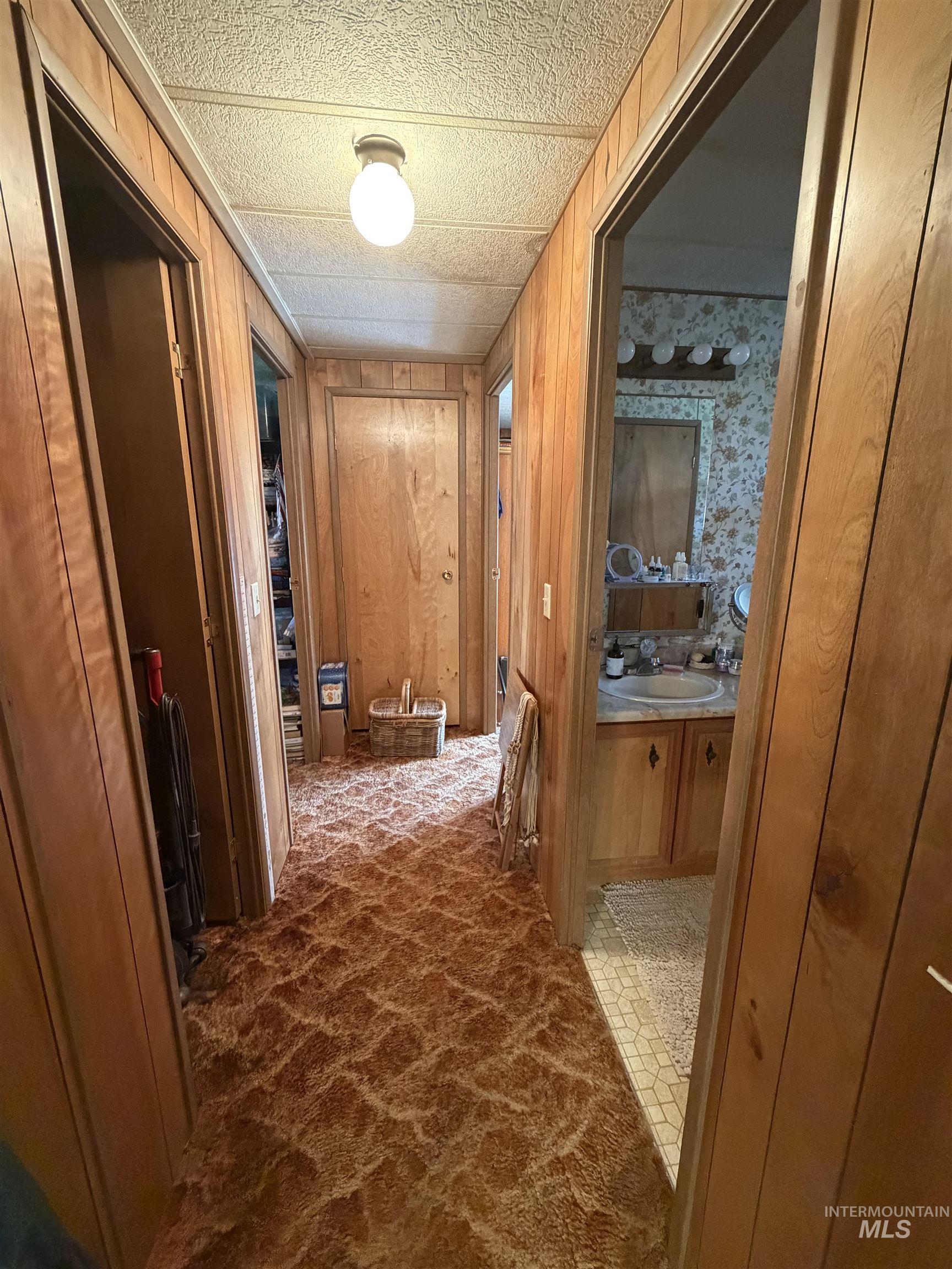 27474 North Tom Beall Road Lapwai, ID 83540 - Photo 33 of 50 Corridor featuring dark carpet and wooden walls