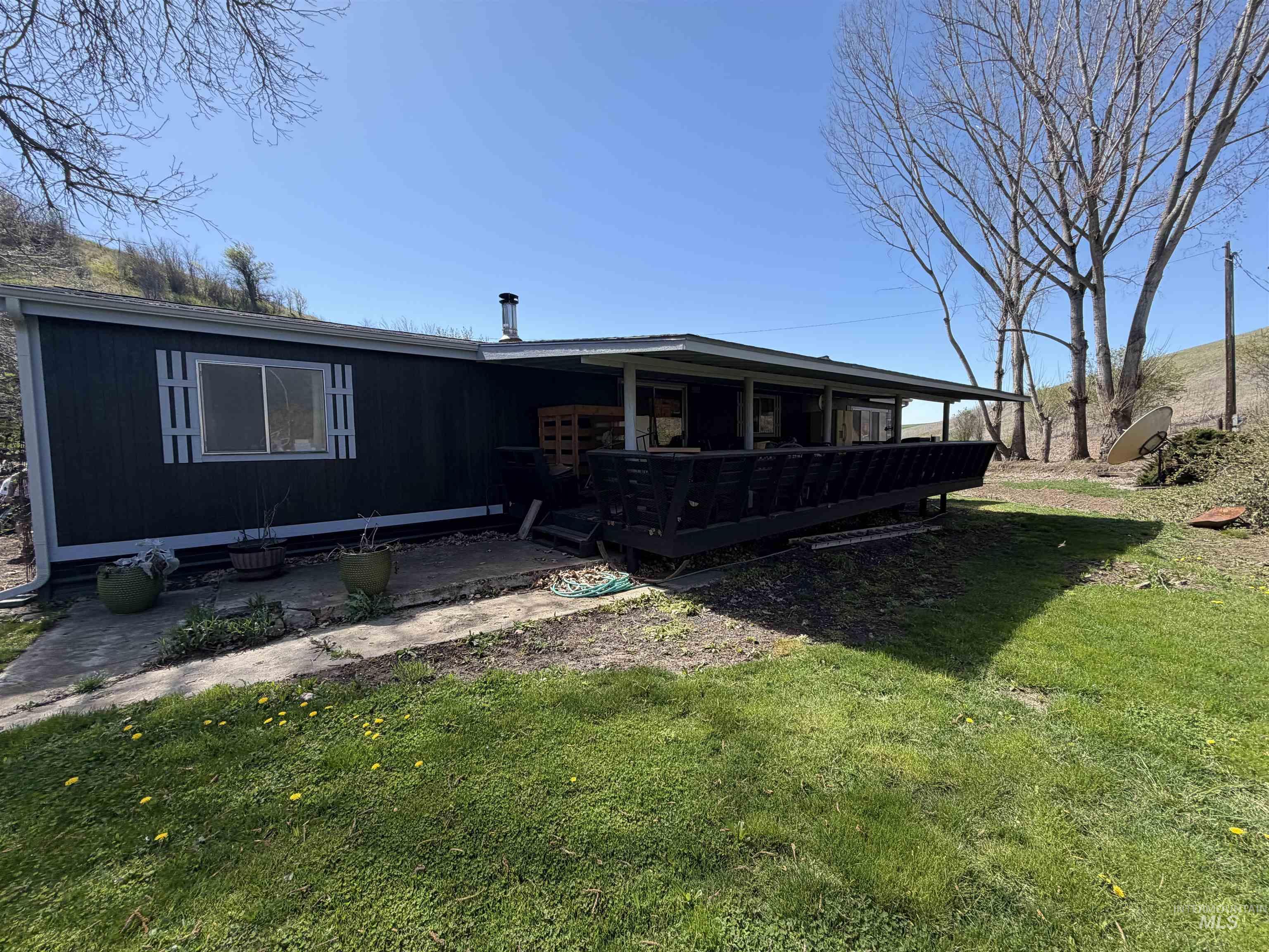 27474 North Tom Beall Road Lapwai, ID 83540 - Photo 4 of 50 Rear view of house featuring a deck and a lawn