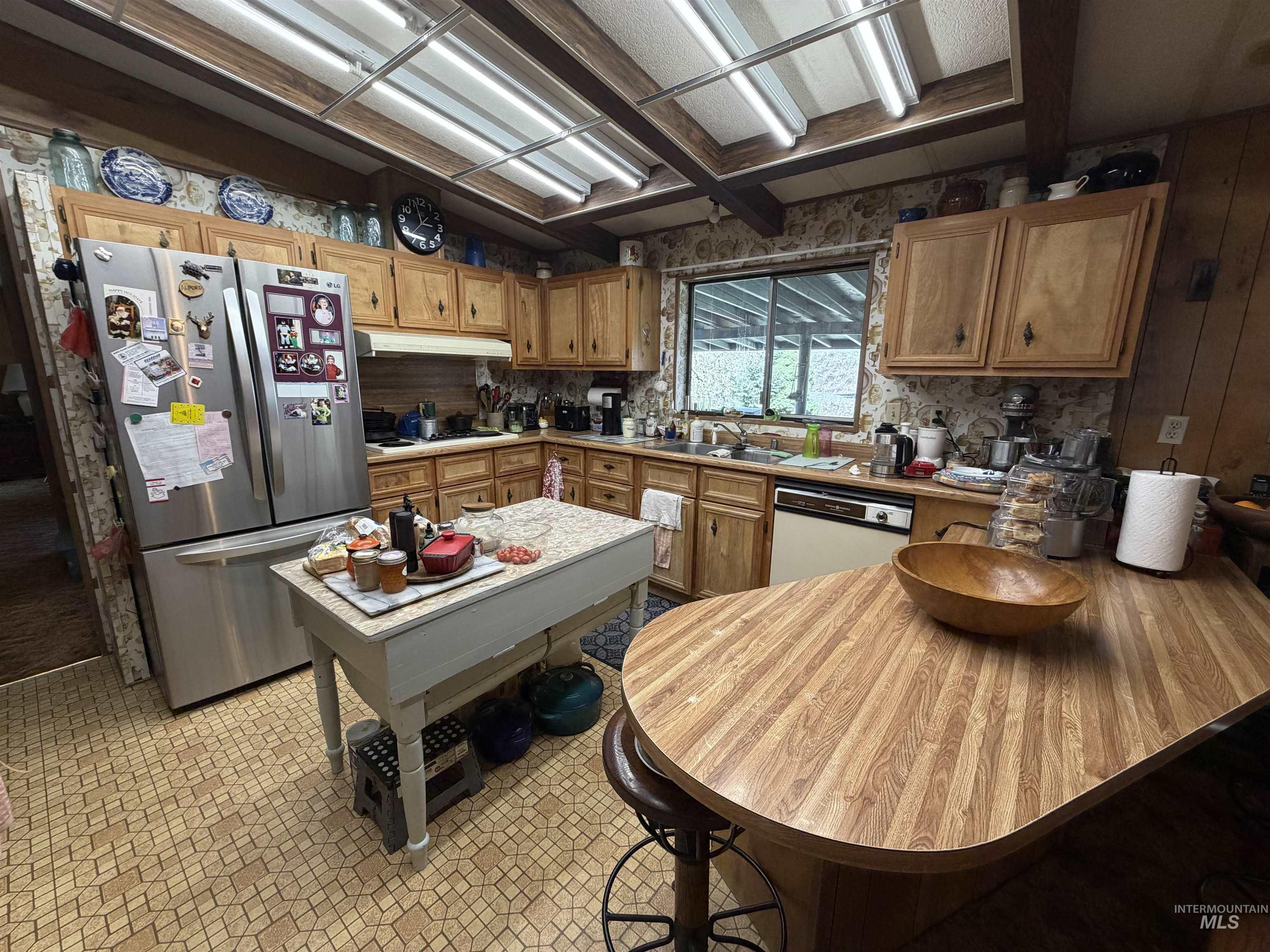 27474 North Tom Beall Road Lapwai, ID 83540 - Photo 41 of 50 Kitchen featuring freestanding refrigerator, wood finish cabinetry, light countertops, and dishwasher