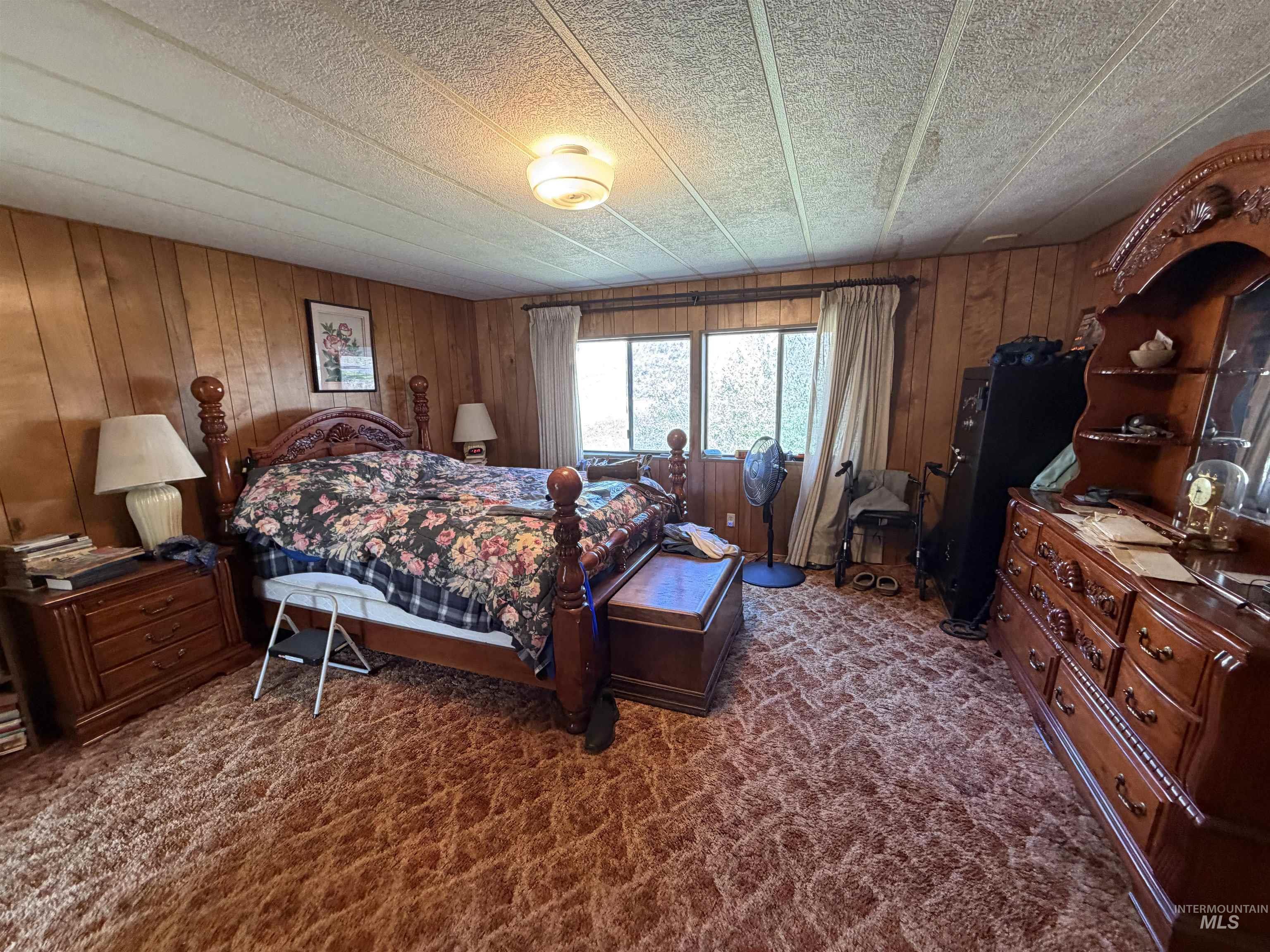 27474 North Tom Beall Road Lapwai, ID 83540 - Photo 47 of 50 Bedroom with wooden walls and dark carpet