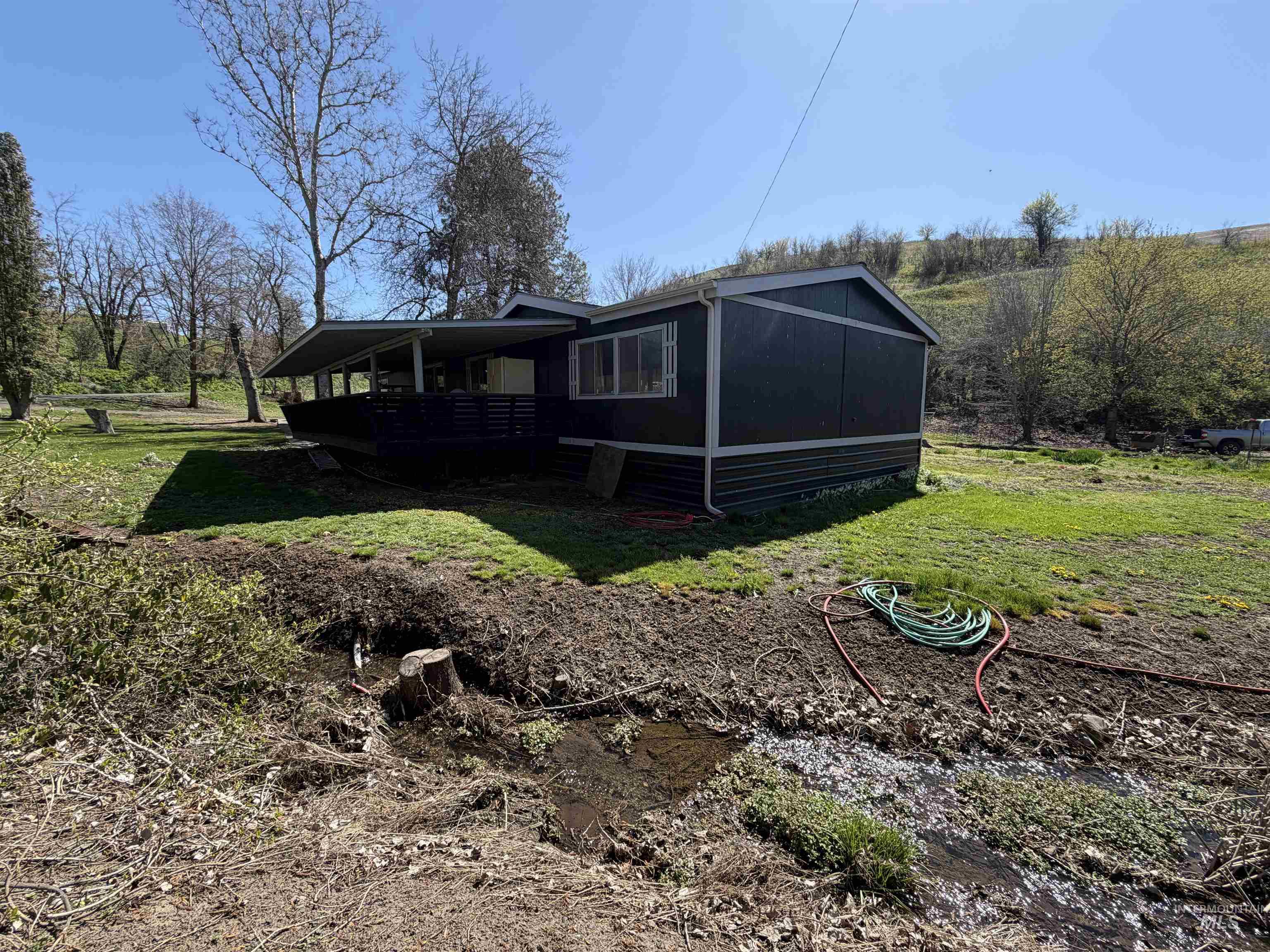 27474 North Tom Beall Road Lapwai, ID 83540 - Photo 7 of 50 View of property exterior featuring a lawn and a wooden deck