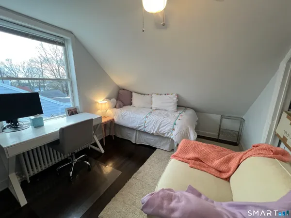 a bedroom with a bed and a desk