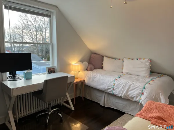 a bedroom with a bed and a desk