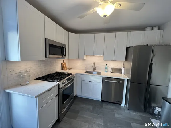 a kitchen with a sink stove and refrigerator