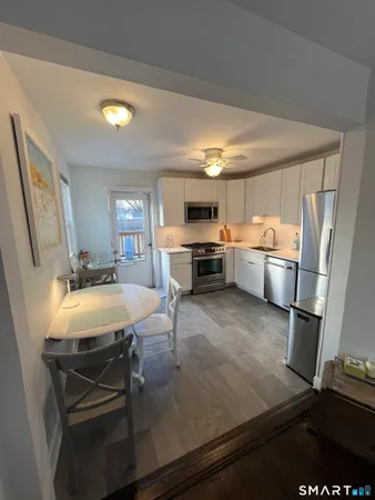 a kitchen with kitchen island a stove a sink and a refrigerator