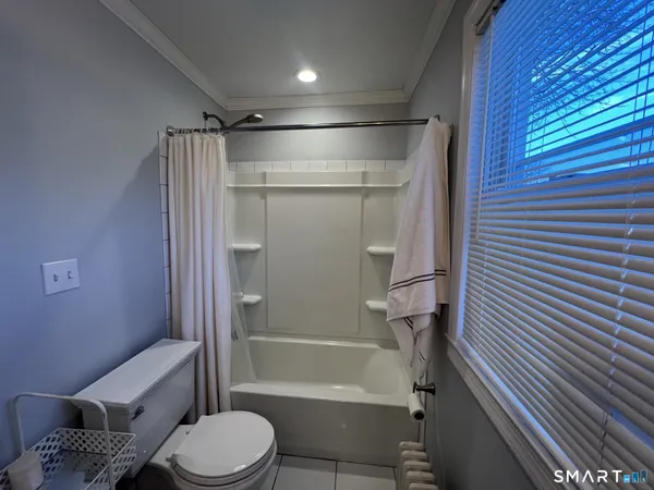 a bathroom with a toilet and a shower