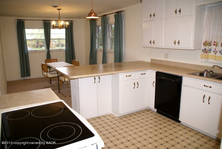 5124 Arden Road Amarillo, TX 79110 - Photo 11 of 42 a kitchen with a sink stove and cabinets