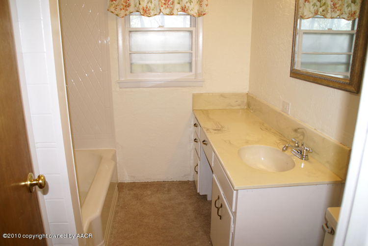 5124 Arden Road Amarillo, TX 79110 - Photo 25 of 42 a bathroom with a sink and a tub