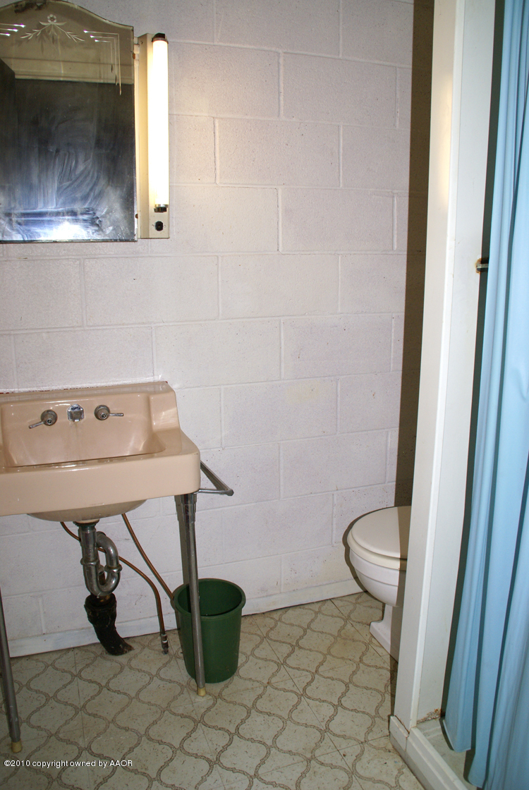 5124 Arden Road Amarillo, TX 79110 - Photo 28 of 42 a view of a bathroom with a sink and a toilet