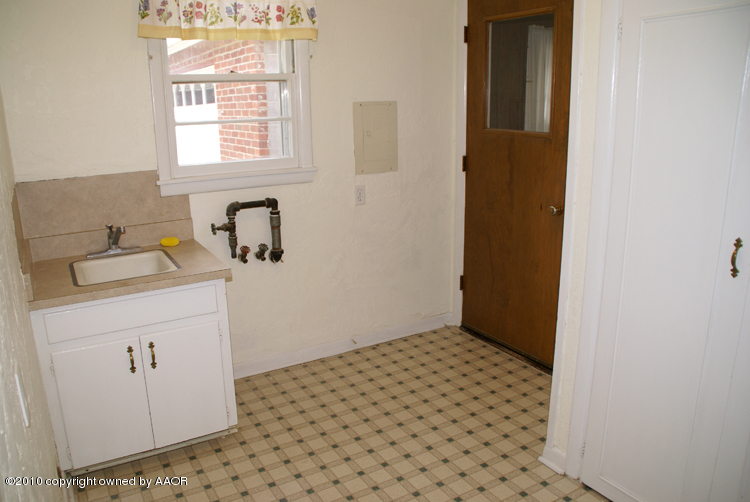 5124 Arden Road Amarillo, TX 79110 - Photo 32 of 42 a bathroom with a sink a window and a mirror