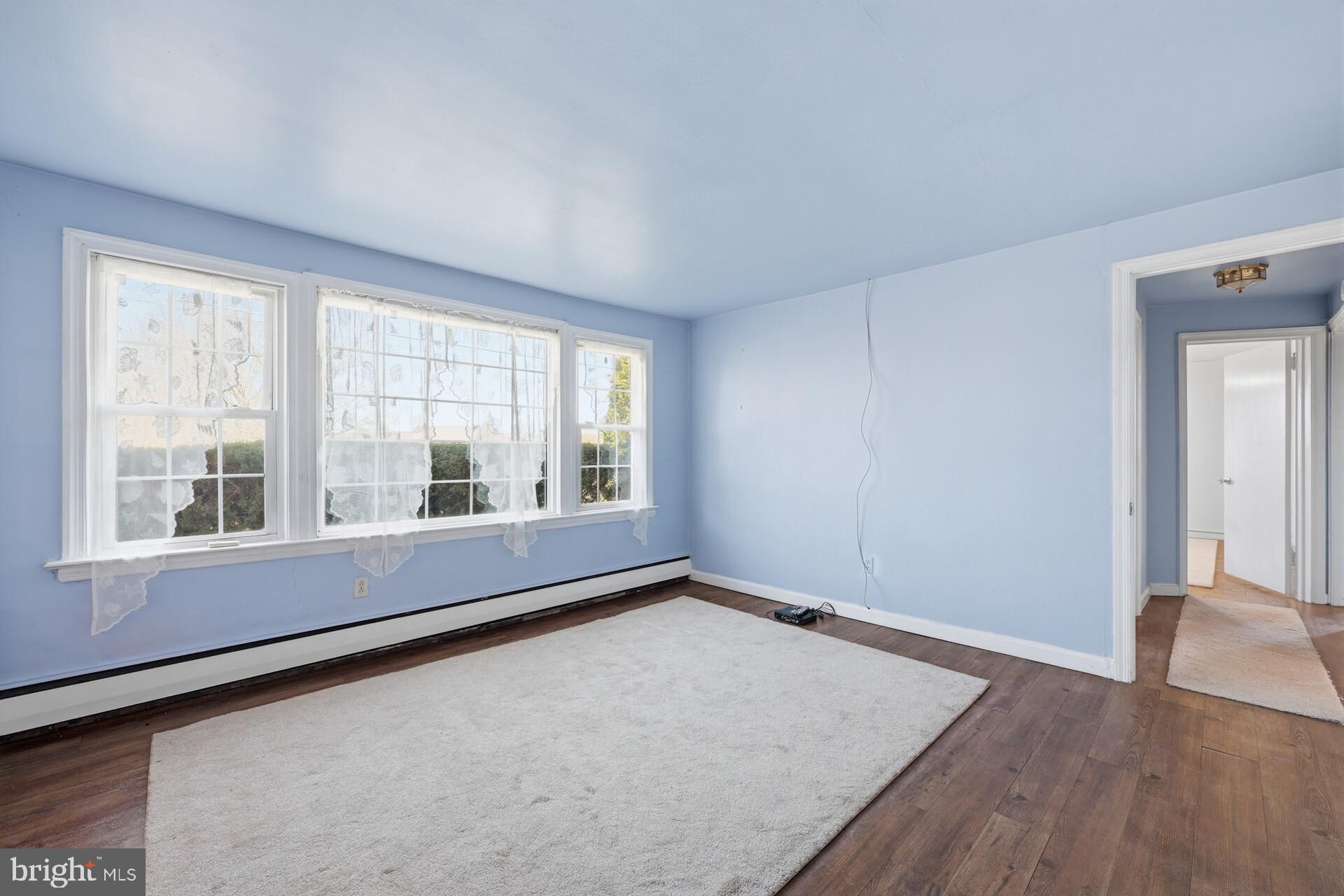 874 Sunset Lane Telford, PA 18969 - Photo 19 of 35 an empty room with wooden floor and windows