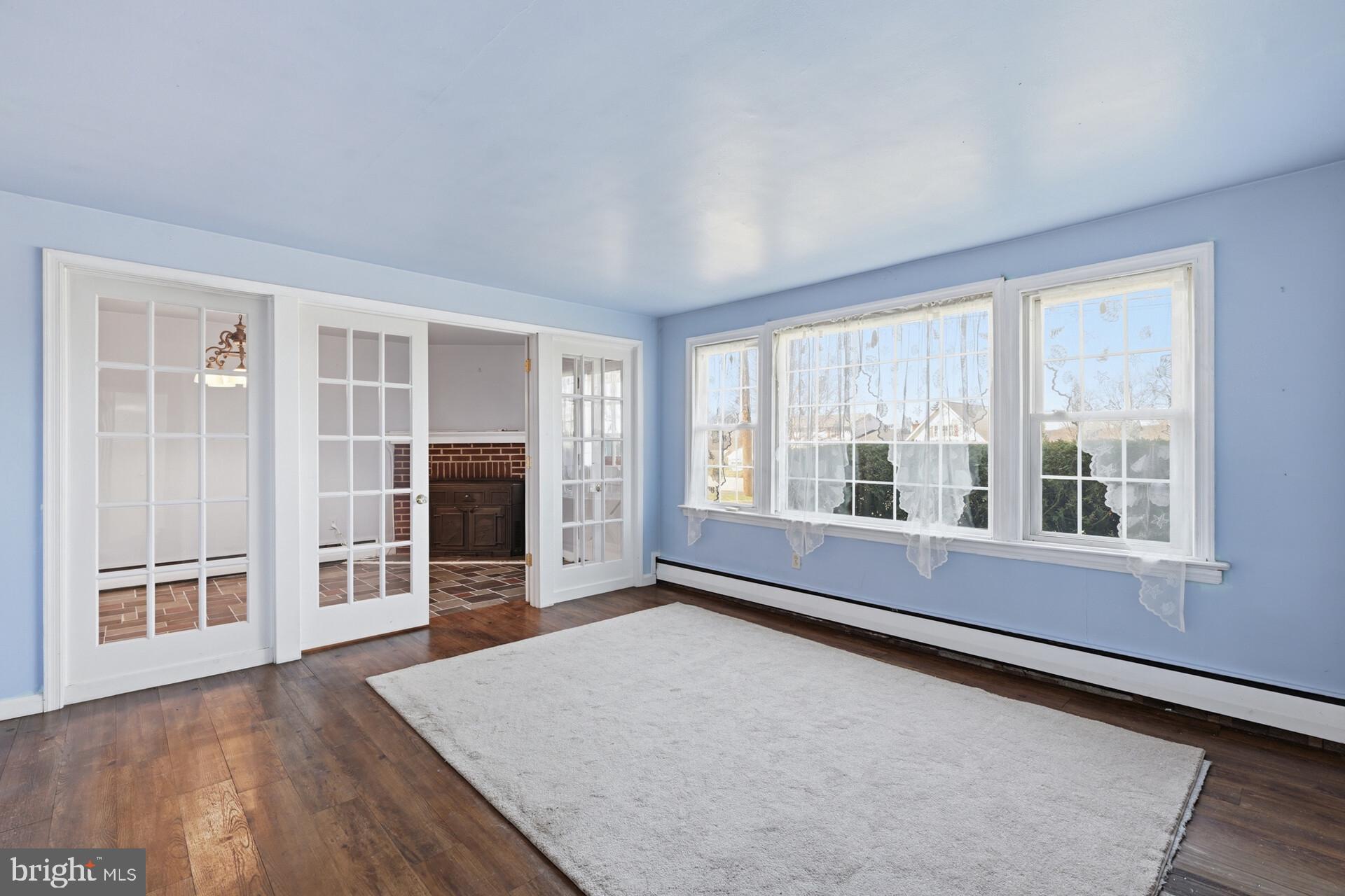 874 Sunset Lane Telford, PA 18969 - Photo 20 of 35 an empty room with wooden floor and windows