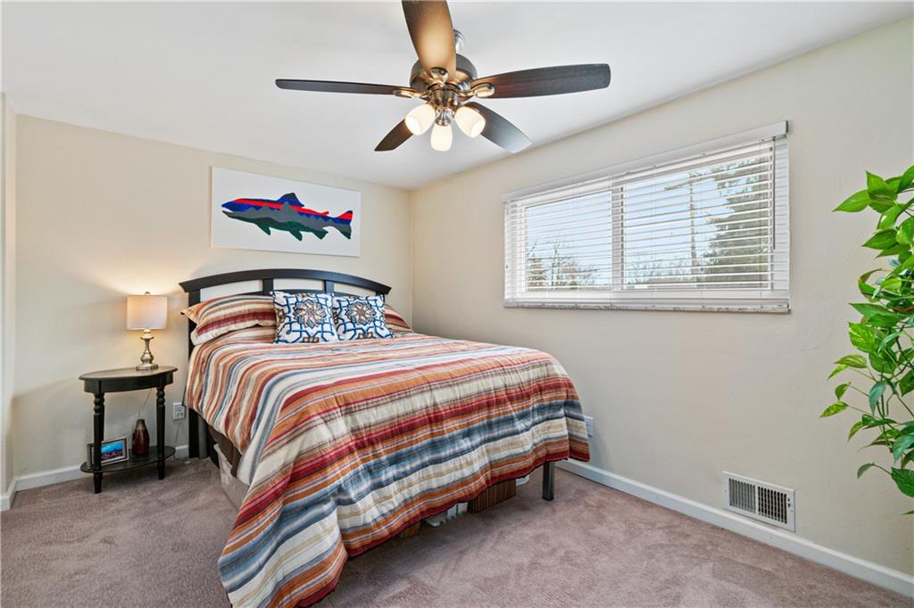 5140 Raintree Drive Pittsburgh, PA 15236 - Photo 18 of 26 a bedroom with a bed and a chandelier