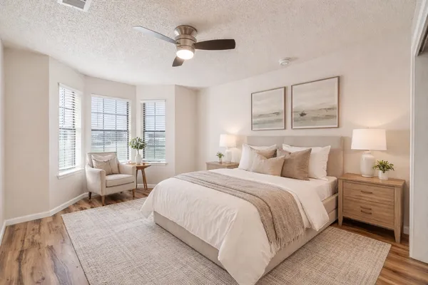 a bedroom with a large bed and a window