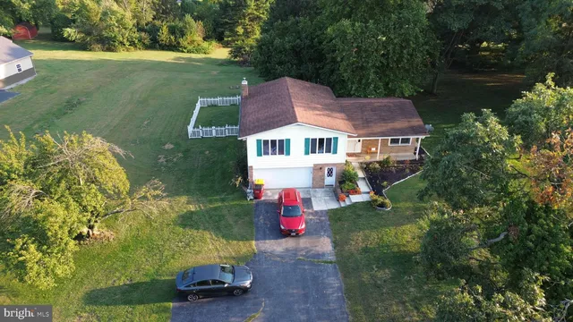 an aerial view of a house with a yard and lake view