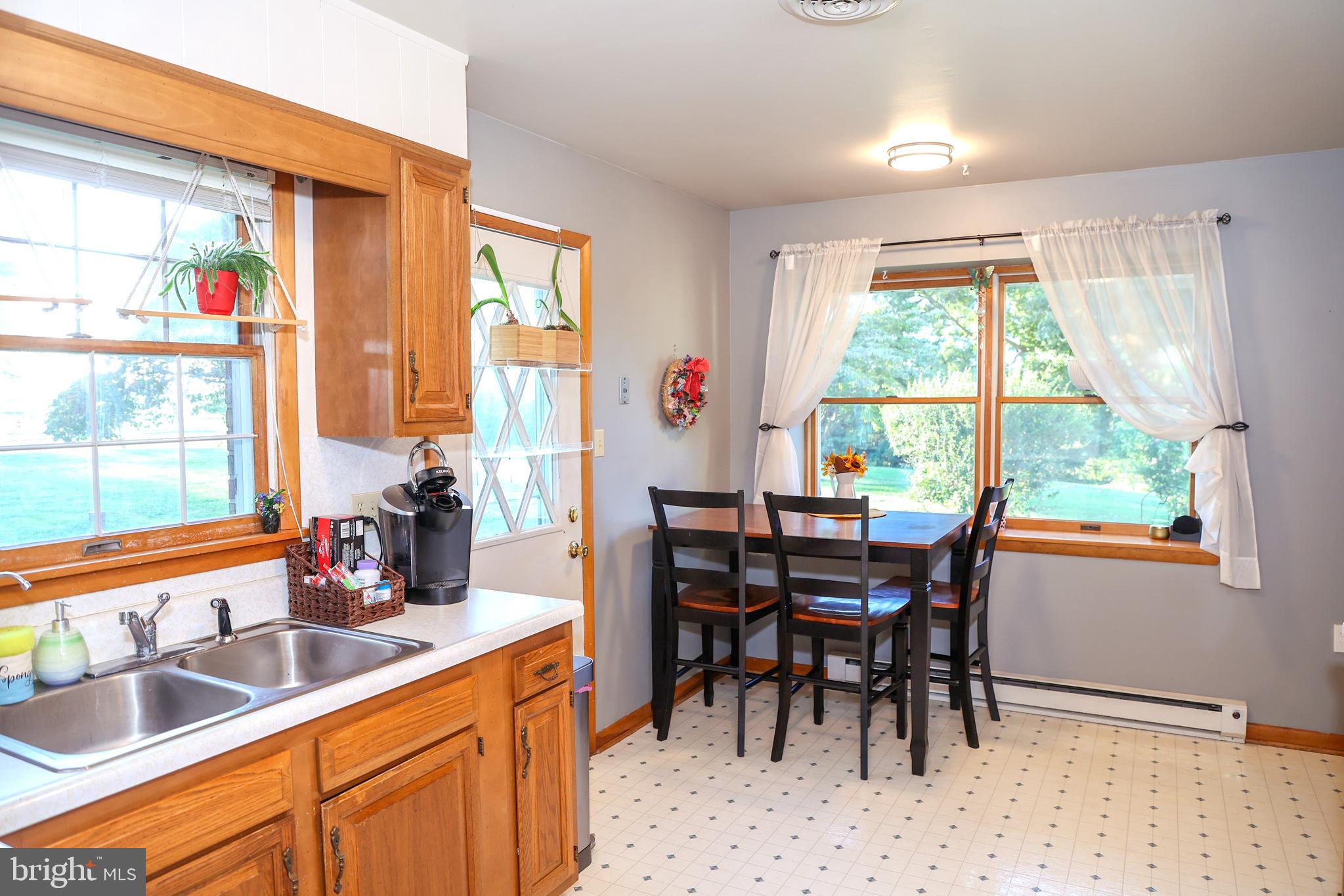 19717 Toms Road Boonsboro, MD 21713 - Photo 16 of 60 a view of a dining room with furniture and a window