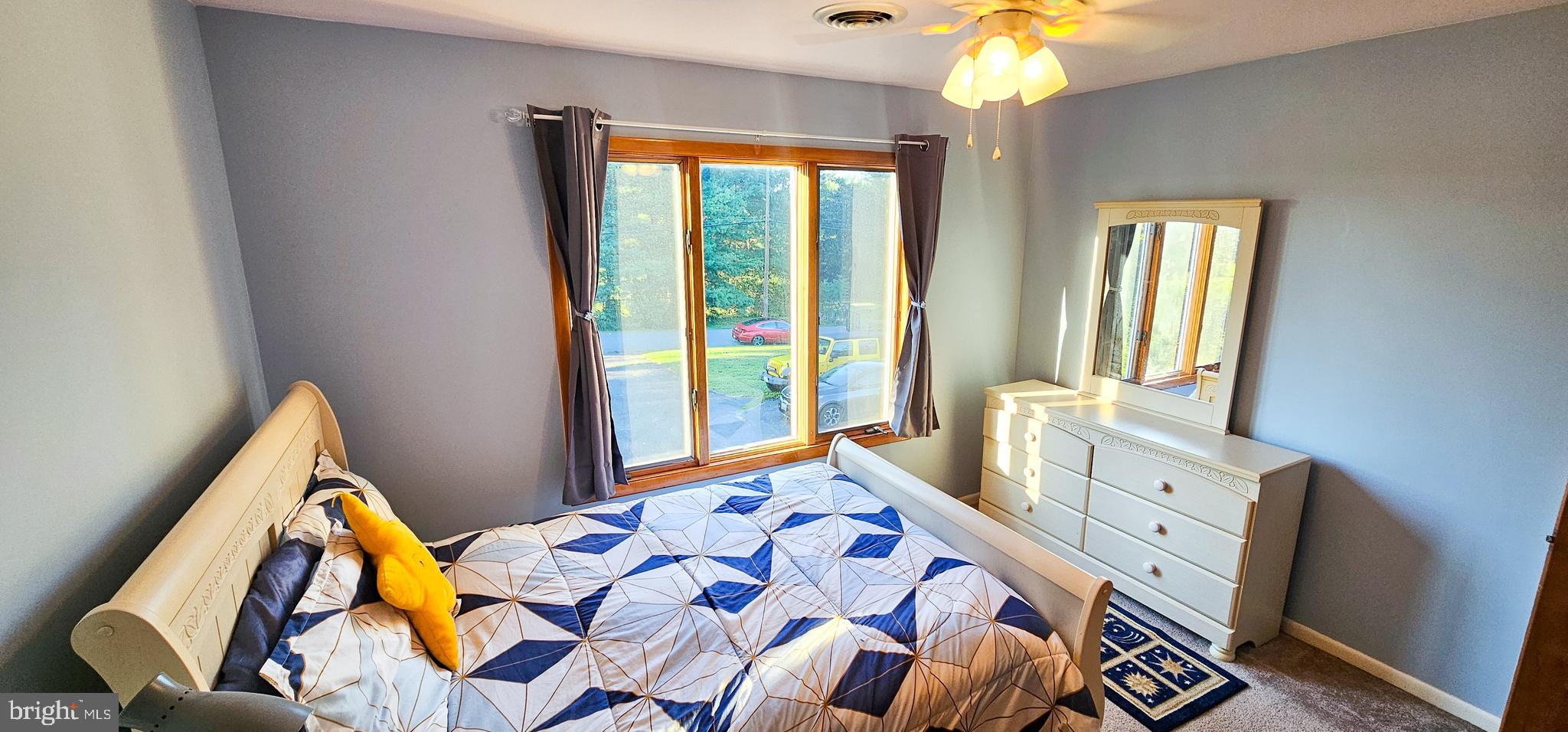 19717 Toms Road Boonsboro, MD 21713 - Photo 18 of 60 a bedroom with a bed and a chandelier