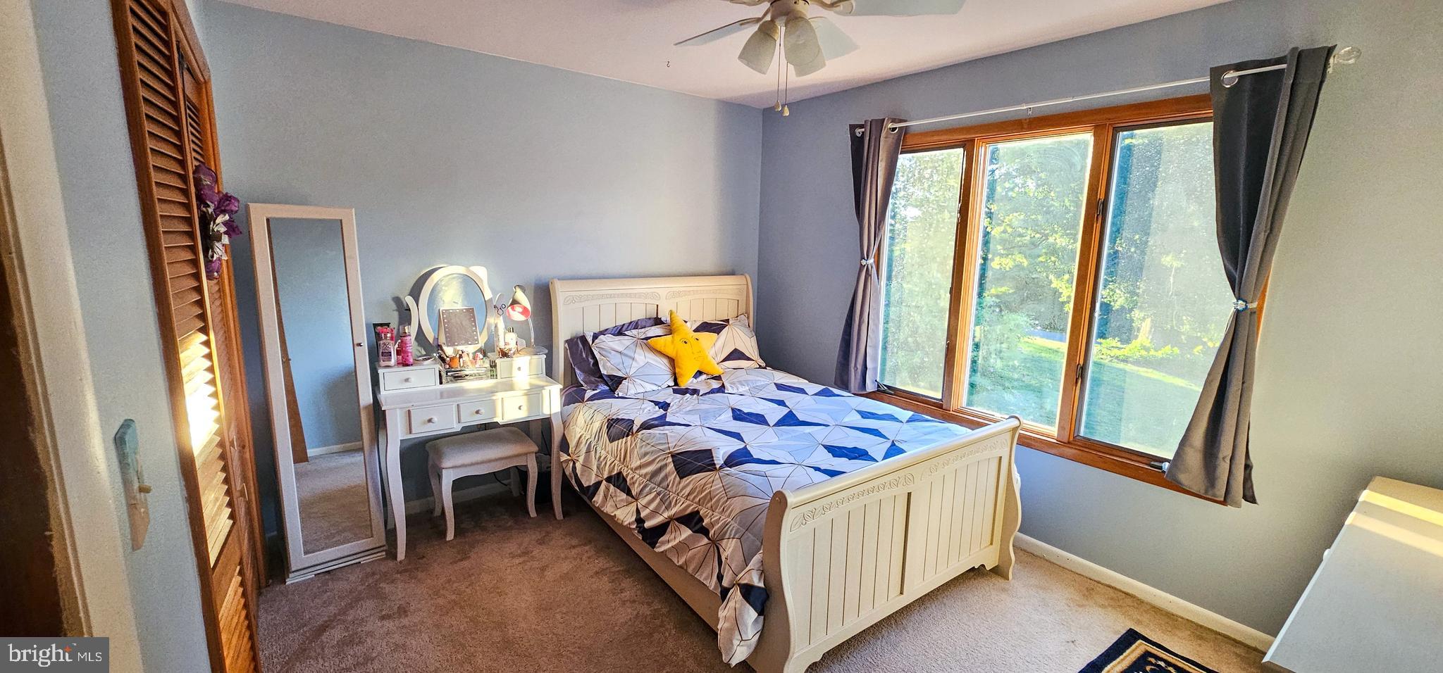 19717 Toms Road Boonsboro, MD 21713 - Photo 19 of 60 a bed sitting in a bedroom next to a window