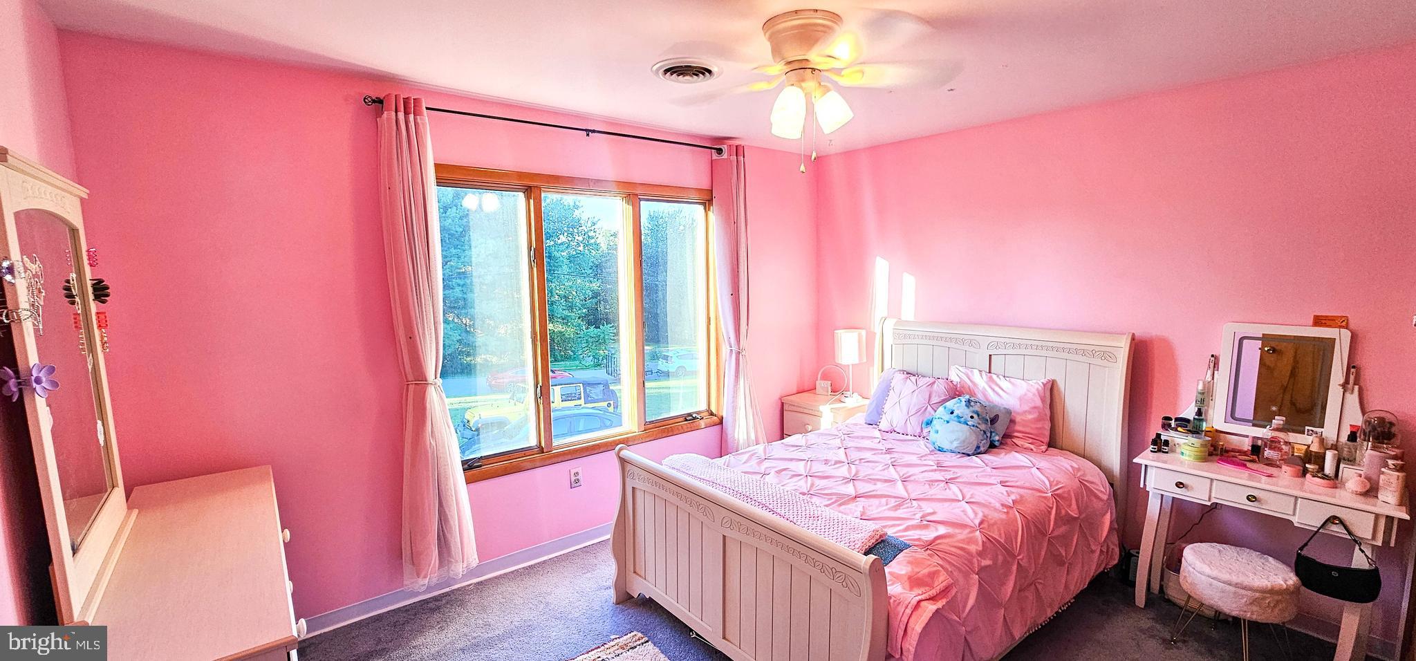 19717 Toms Road Boonsboro, MD 21713 - Photo 22 of 60 a bedroom with a bed and a chandelier