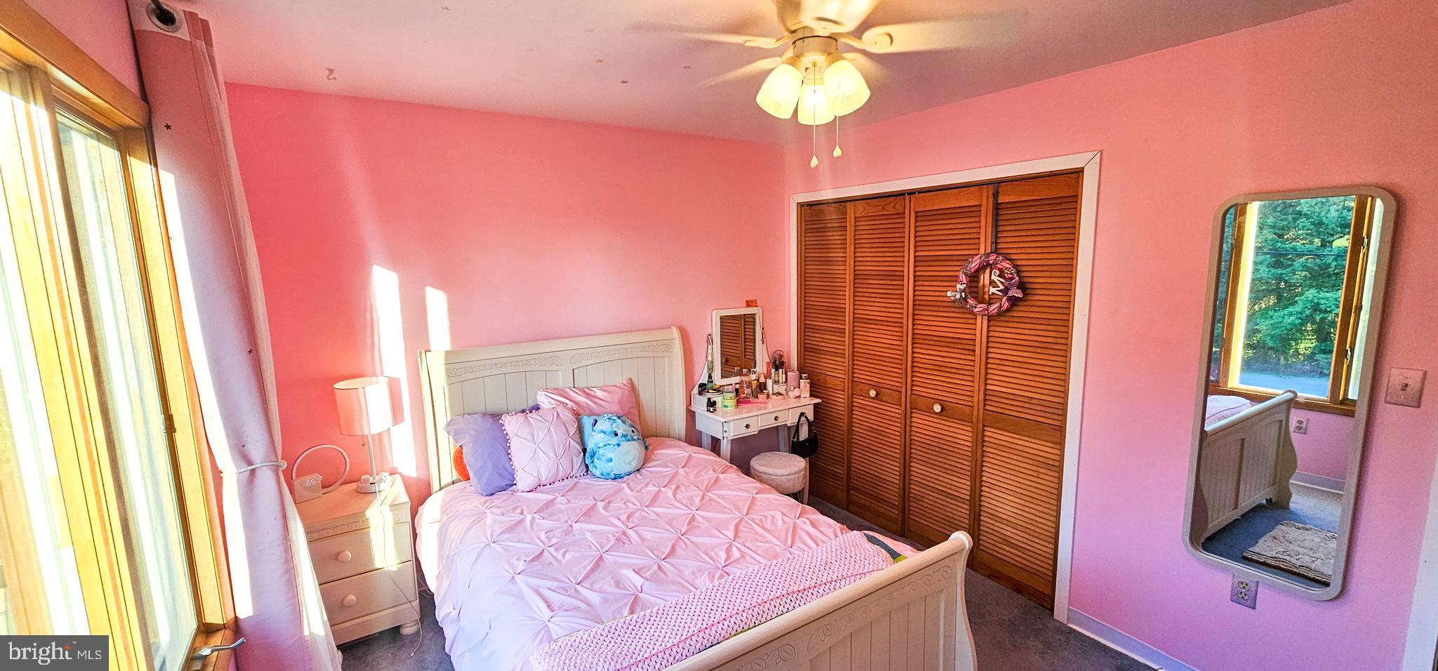 19717 Toms Road Boonsboro, MD 21713 - Photo 23 of 60 a bedroom with a bed and a chandelier