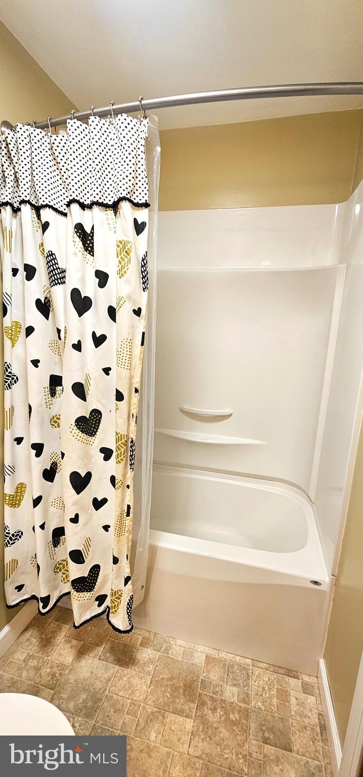 19717 Toms Road Boonsboro, MD 21713 - Photo 32 of 60 a bathroom with a bathtub and a shower