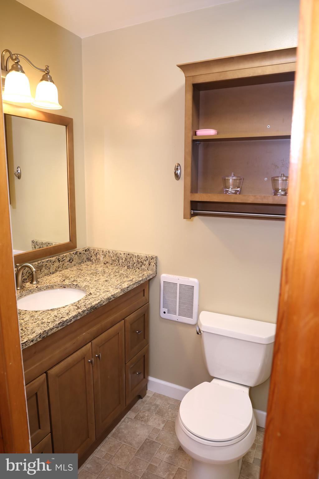 19717 Toms Road Boonsboro, MD 21713 - Photo 33 of 60 a bathroom with a granite countertop toilet sink and mirror
