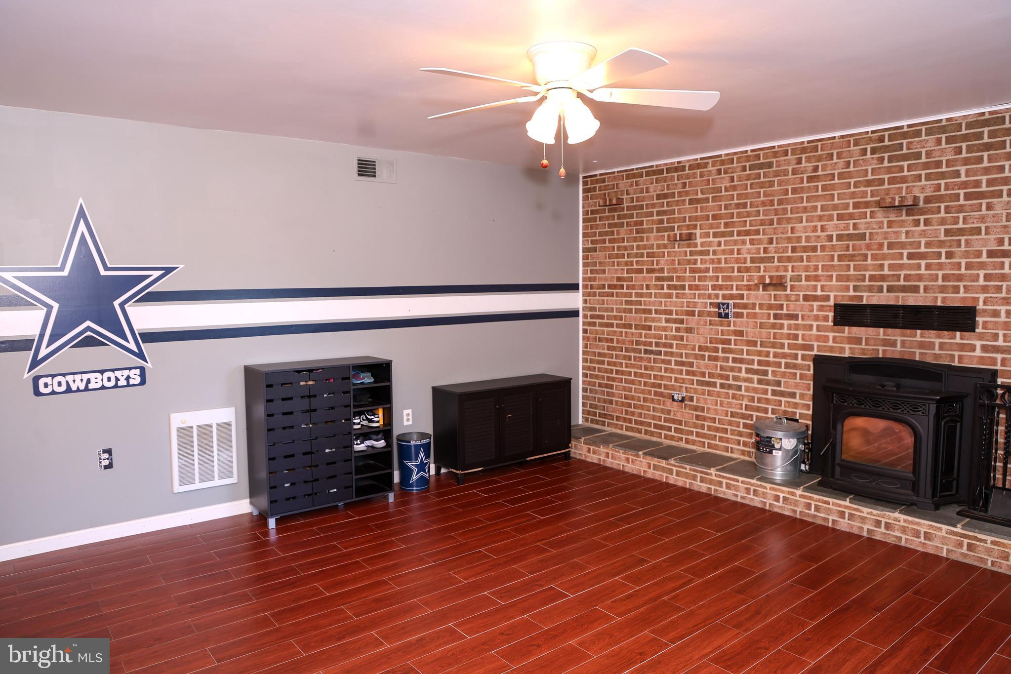 19717 Toms Road Boonsboro, MD 21713 - Photo 36 of 60 a view of a livingroom with wooden floor and a fireplace