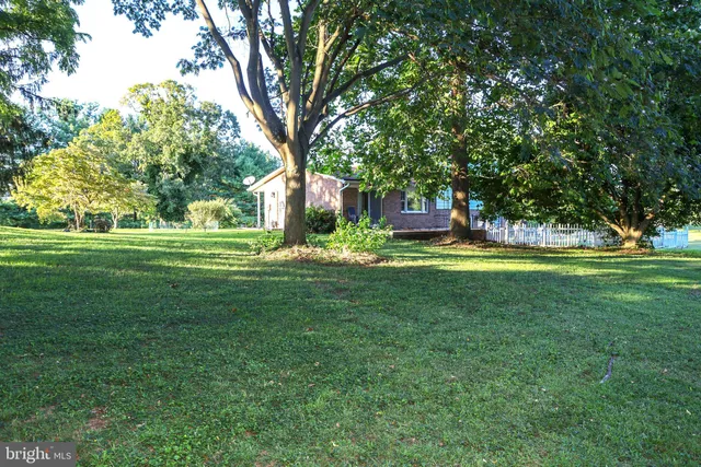 an aerial view of a house with a yard basket ball court and outdoor seating
