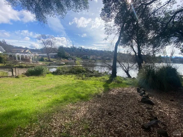 a view of a lake with a yard