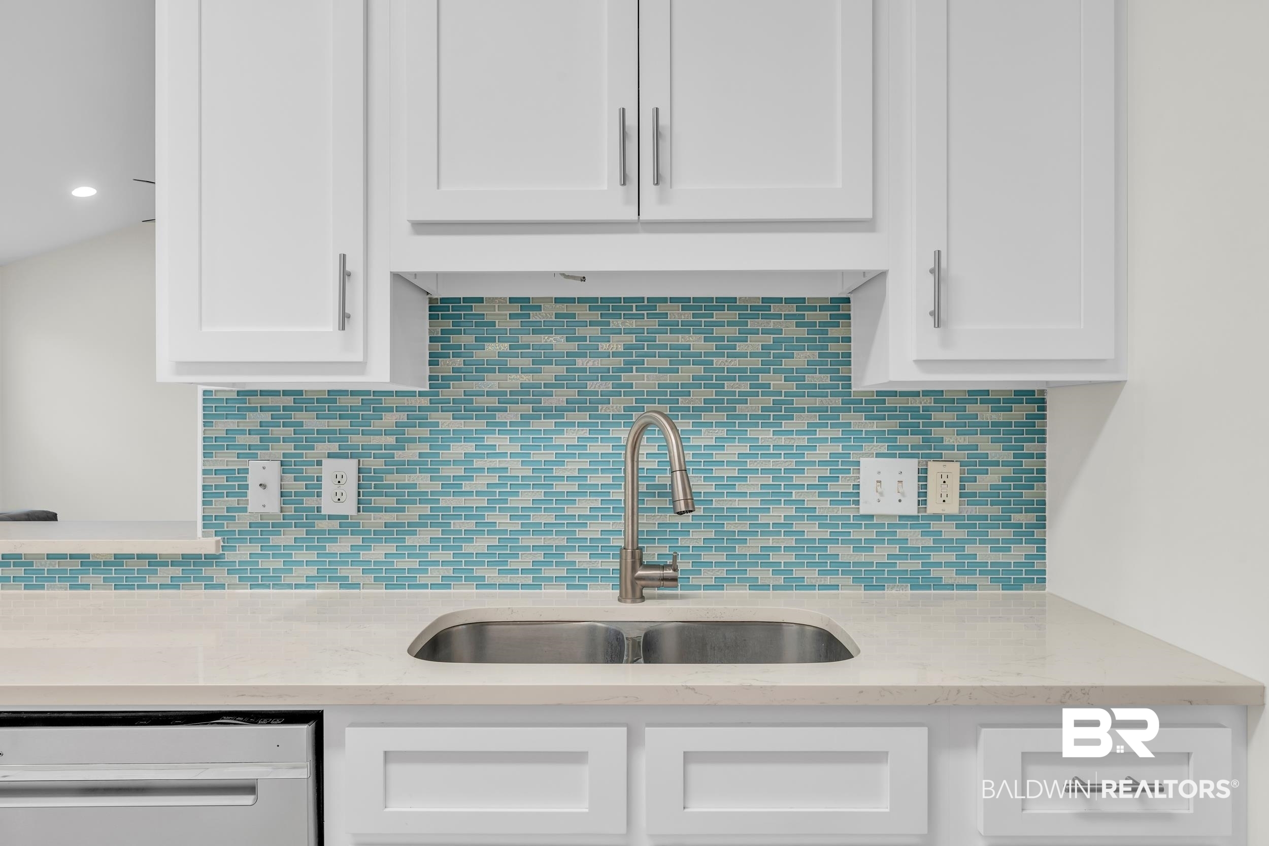 4606 Osprey Drive Orange Beach, AL 36561 - Photo 22 of 44 Kitchen featuring dishwasher, white cabinetry, and tasteful backsplash