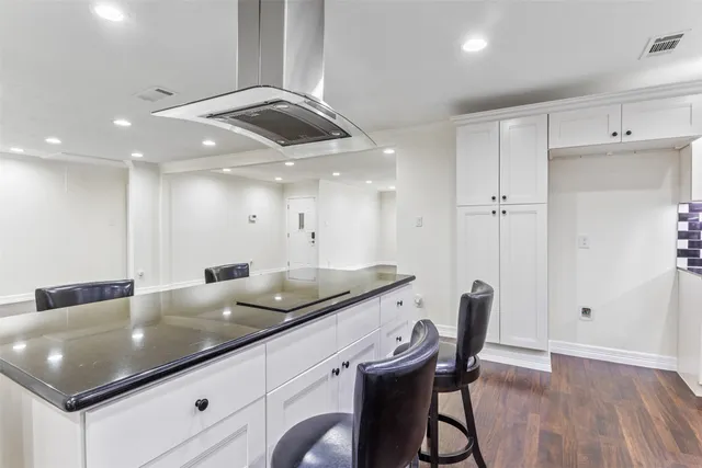 a kitchen with granite countertop a sink a counter space and dining table