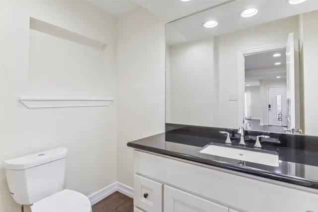 a bathroom with a granite countertop sink and a mirror