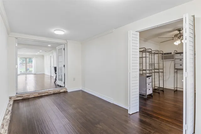 a view of empty room with wooden floor