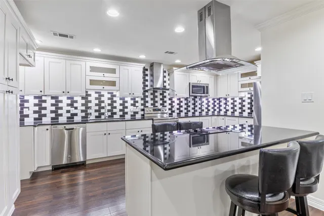 a kitchen with stainless steel appliances granite countertop a sink and cabinets