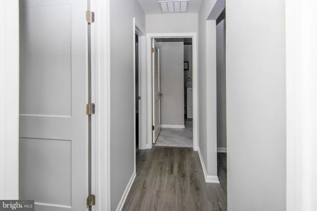 a view of a room with wooden floor