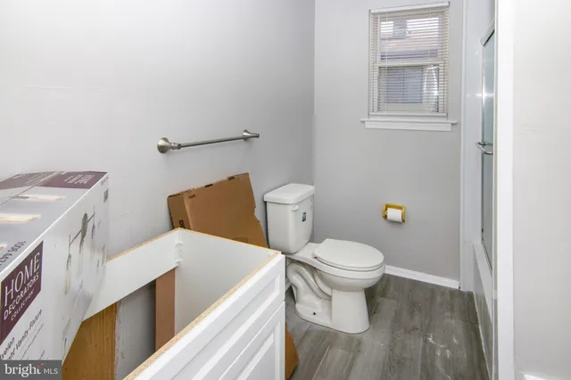 a white toilet sitting next to a bathroom sink