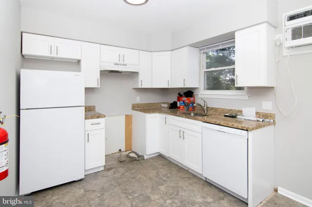 a kitchen with refrigerator and cabinets